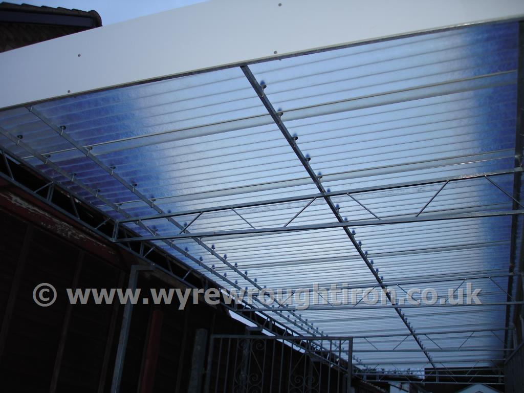 Detail of carport in Fleetwood showing steel structure and near transparent fibreglass roof.