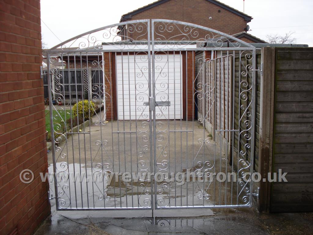 Tall double arched gates in Thames design with a galvanised finish, completed for a client in Bispham, near Blackpool.