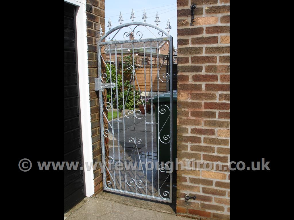 Tall single gate in galvanised finish with slide bolt for a padlock to secure this rear garden in Layton, Blackpool. Spiked finials add extra security as something uncomfortable to climb over.
